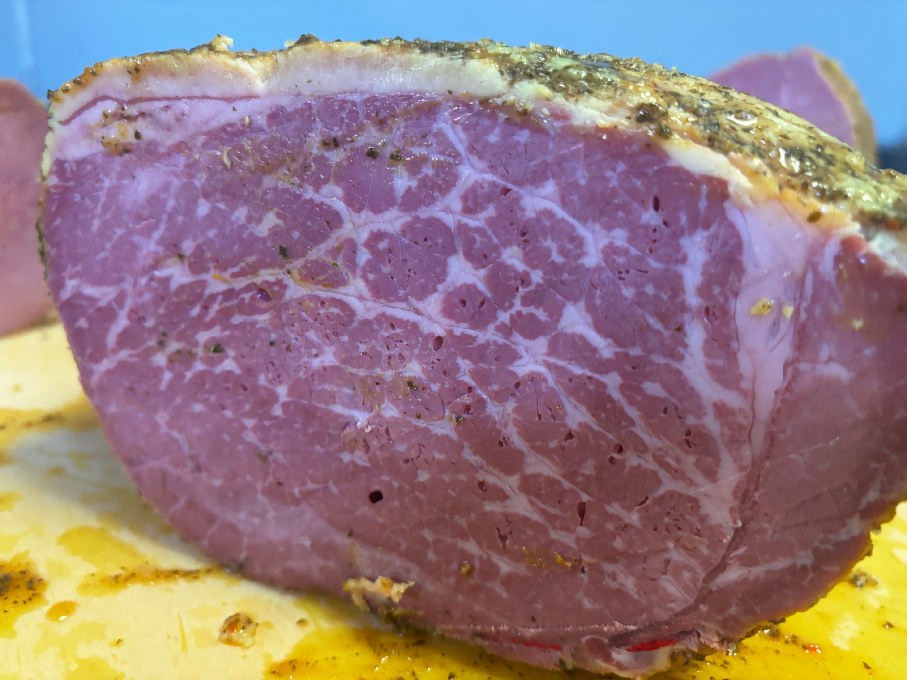 Close-up of seasoned pastrami with a rich spice crust